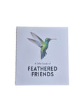 A hardcover copy of "A Little Book of Feathered Friends" by Loren Boyd featuring colorful bird illustrations on the cover. nz