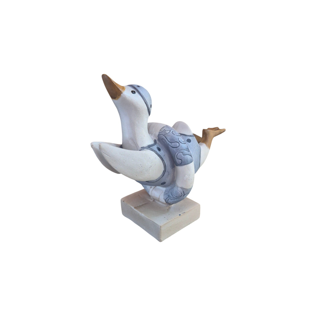 Loren Boyd duck diving through swim ring figurine displayed on a white background, showcasing detailed craftsmanship.