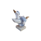Loren Boyd duck diving through swim ring figurine displayed on a white background, showcasing detailed craftsmanship.