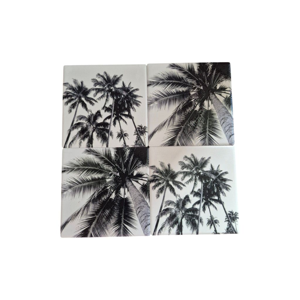 Set of four black and white palm tree coasters by Loren Boyd, featuring tropical leaf designs for stylish table protection. nz