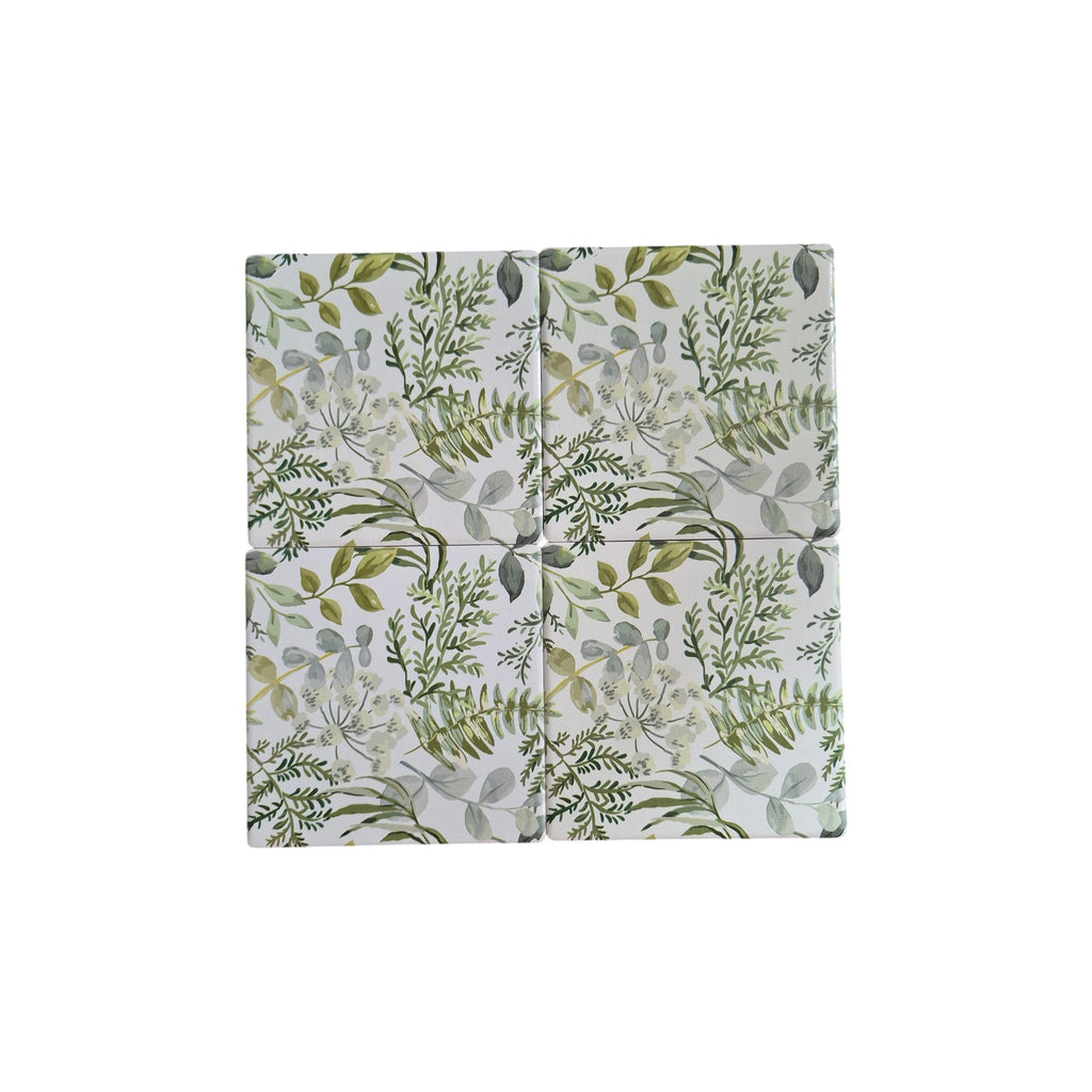 Set of four botanical garden-themed coasters by Loren Boyd featuring vibrant floral and leaf patterns on cork bases. nz