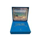 Six Loren Boyd Beach Balconies coasters with colorful seaside balcony designs on a wooden table. nz