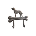 Loren Boyd Dog & Bone cast iron double wall hook mounted on a wall, featuring a decorative dog and bone design for hanging items. nz