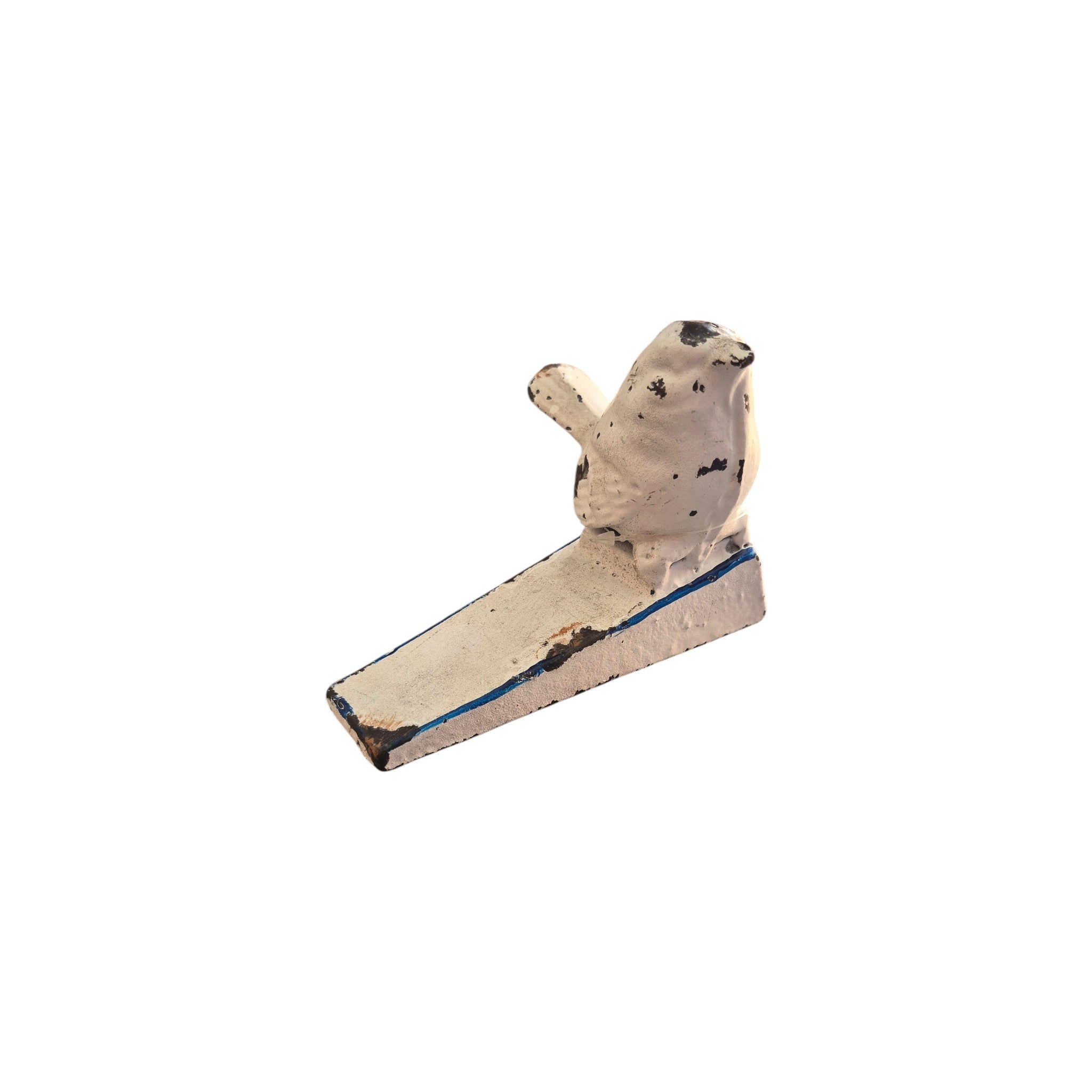 Distressed white bird cast iron door wedge door stop by Loren Boyd sitting on a wooden floor. nz