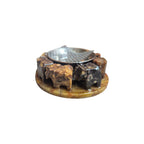 Top view of metal bowl and mesh above a circle of carved soapstone elephants