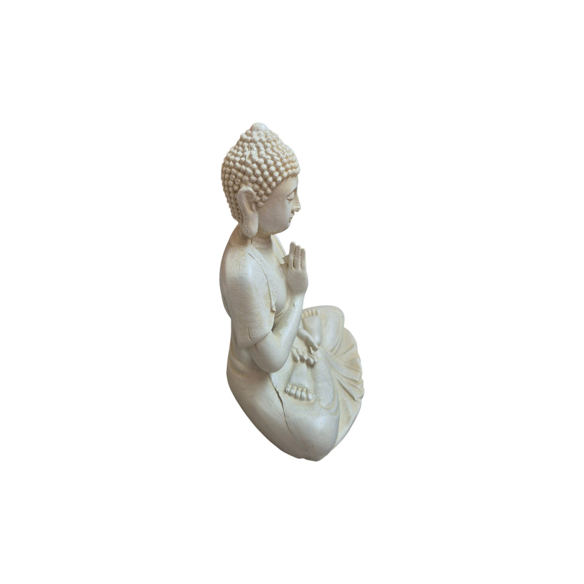 Side view of white resin Buddha showing raised hand and draped robe