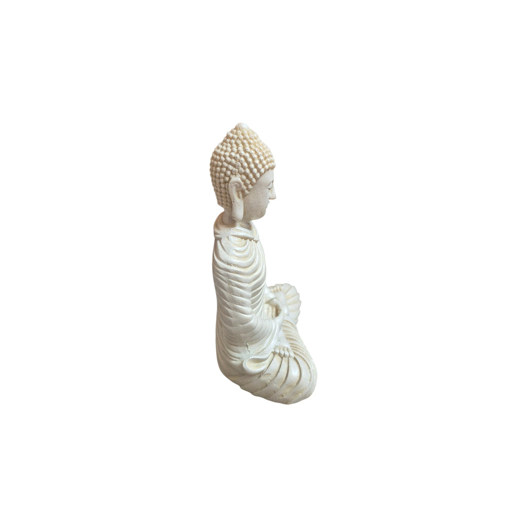 Side view of white resin meditation Buddha showing ridged robe and seated pose