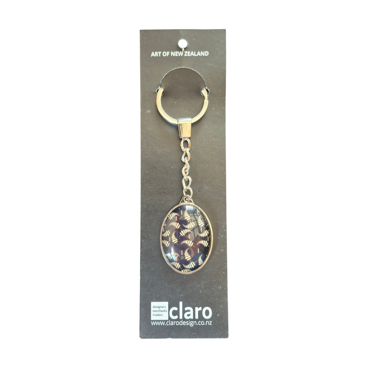 Claro Fern Keychain on display card showing silver oval glass dome with NZ fern pattern nz