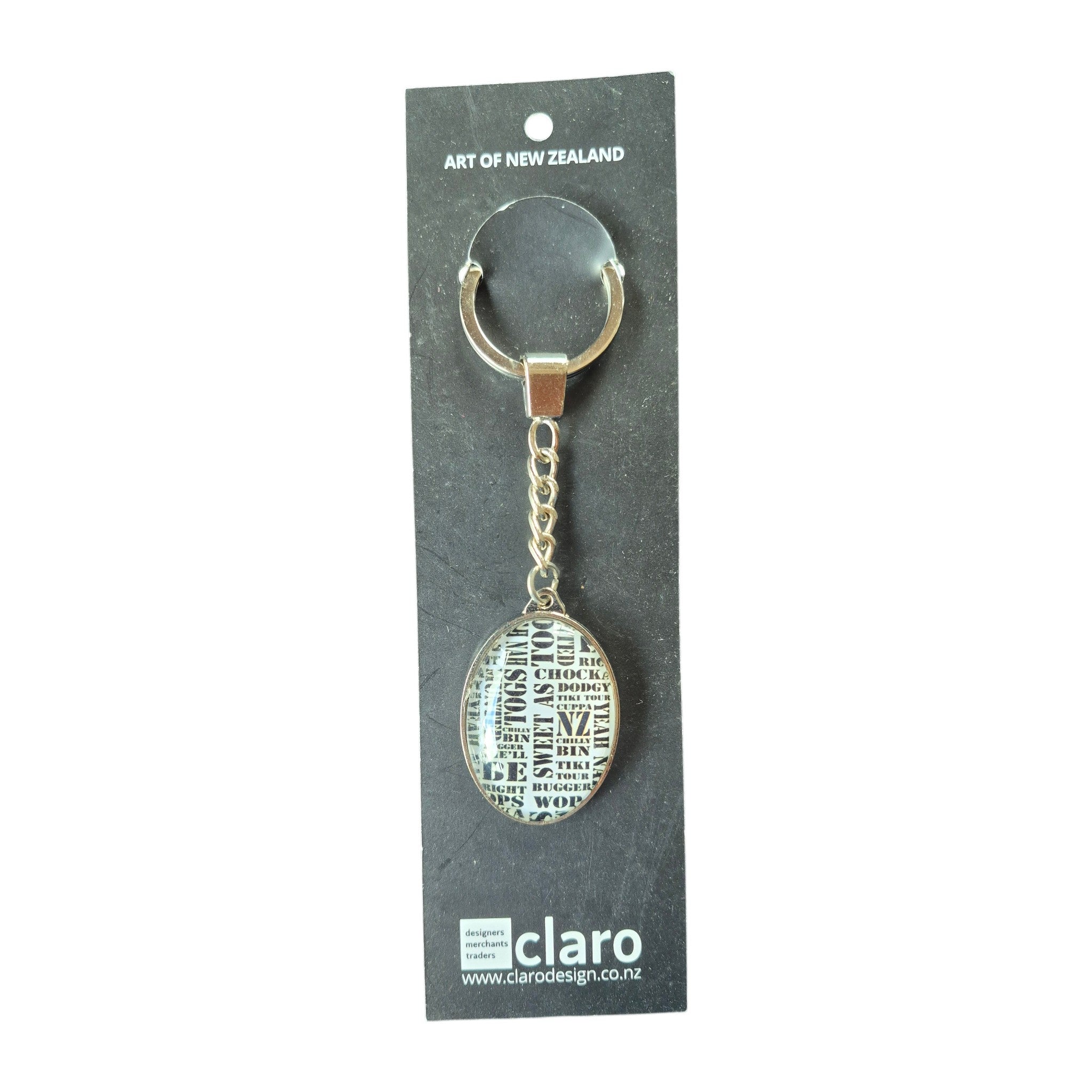 Claro Kiwi Slang Keychain on display card showing silver oval glass dome with NZ slang words typography
