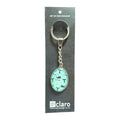 Claro Whale Keychain on display card showing silver oval glass dome with whale and whale tail pattern on aqua background