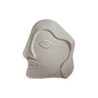 White Face Sandstone Vase front view showing abstract carved face profile with single eye and speckled white finish