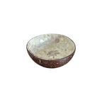 Bali Hi Coconut Bowl angled view showing pearlescent mother-of-pearl interior with palm tree motif and natural coconut exterior