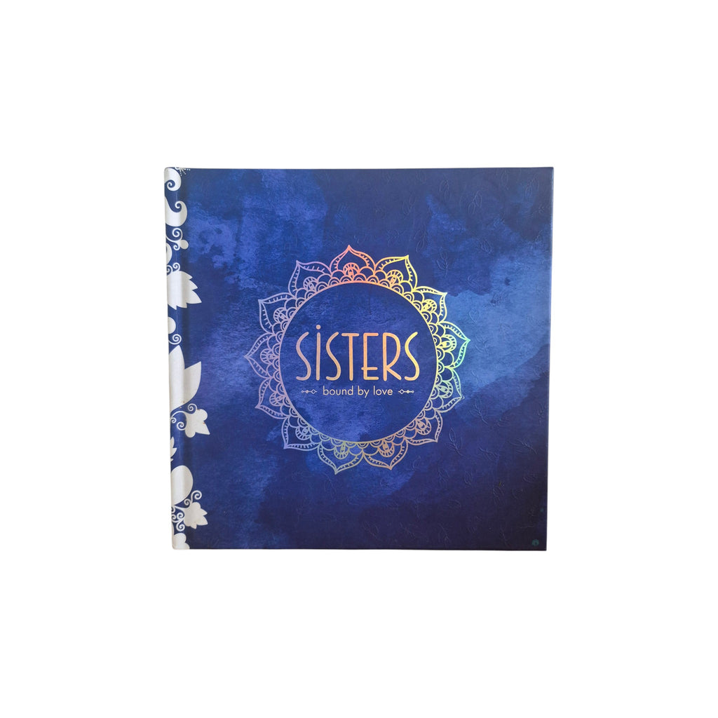 Sisters Bound by Love hardback book — deep midnight blue cover with holographic rainbow foil mandala design and Sisters Bound by Love gold lettering
