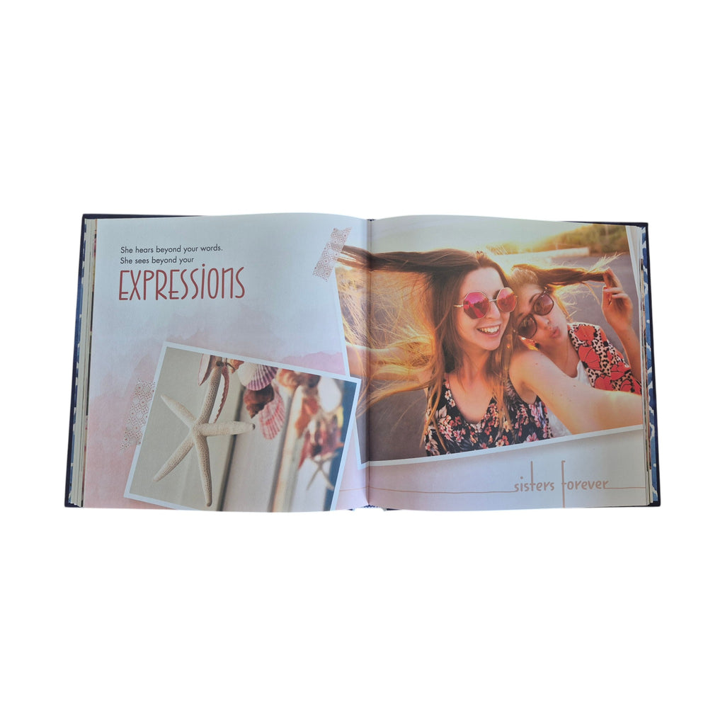 Sisters Bound by Love hardback book — open spread showing full-colour photography of two young women, inspirational quote and keepsake journalling space
