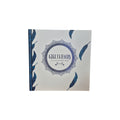 Girlfriends An Unbreakable Bond hardback book — white cover scattered with navy blue feathers and central decorative mandala emblem with teal cloth spine