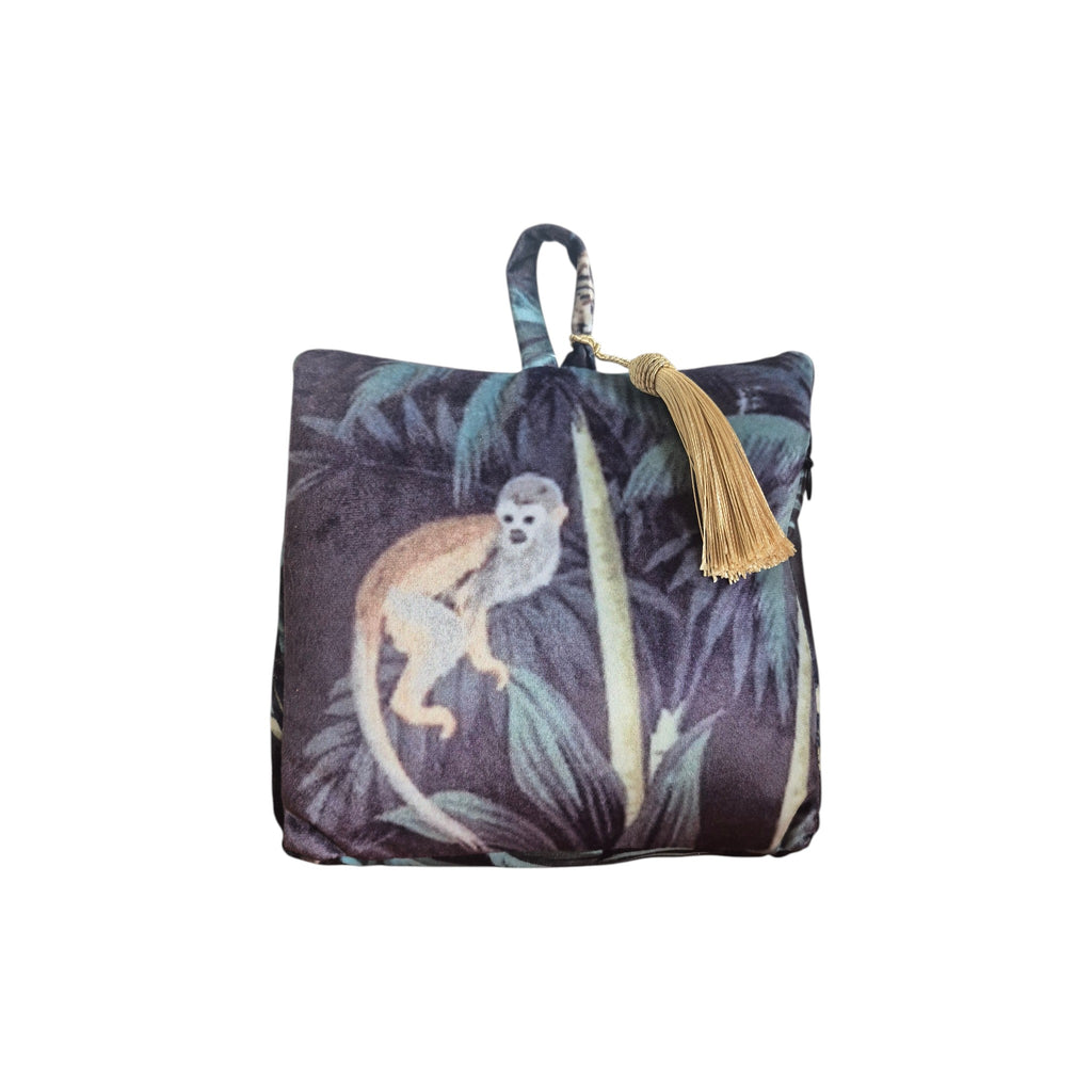 Jungle Velvet Doorstop Black by LeForge — front view showing squirrel monkey perched amongst teal and charcoal jungle foliage with antique gold tassel
