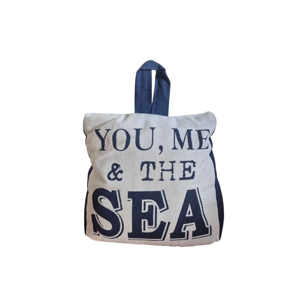 You Me and the Sea Doorstop by LaVida — front view showing natural cream woven fabric with bold navy YOU ME & THE SEA typographic lettering and navy loop handle
