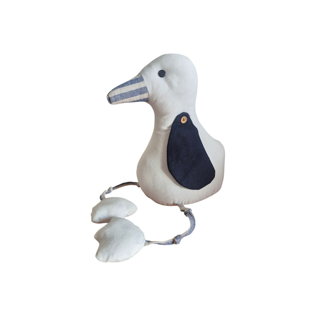 LaVida Seagull Doorstop side view showing natural cream linen fabric seagull with navy wing patch, wooden button, striped beak, rope legs and webbed feet