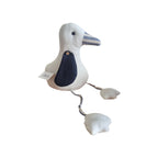 LaVida Seagull Doorstop angled view showing LaVida label, navy wing detail with wooden button and striped fabric beak on cream linen body