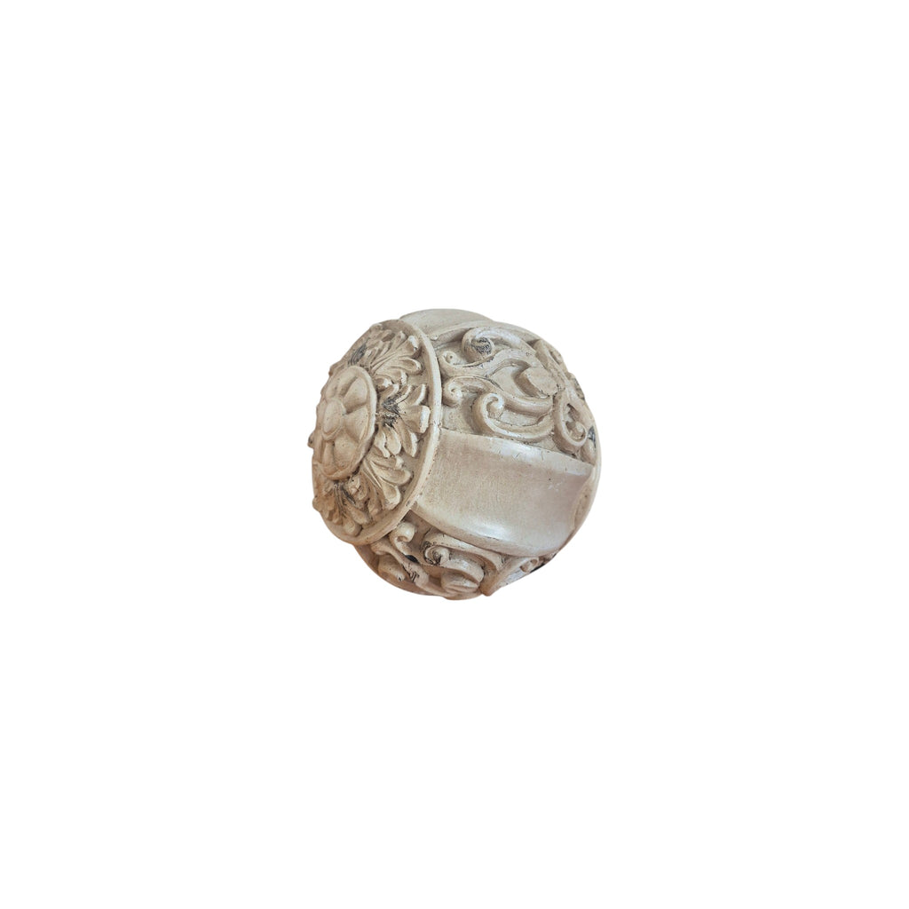 Ivory Scroll Decorative Ball angled view showing ornate carved scrolling acanthus leaf and botanical motifs with antiqued silver wash