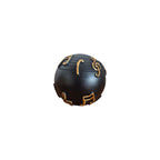 Musical Notes Decorative Ball front view showing matte black ball with raised antique gold treble clef and quaver note symbols