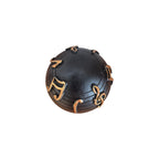Musical Notes Decorative Ball top down view showing full arrangement of raised gold musical notes and staff lines on matte black surface
