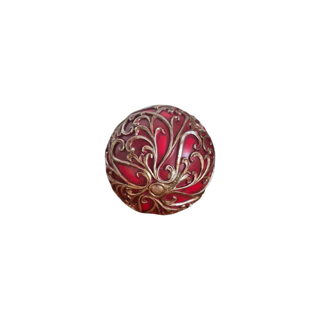 Red and Gold Filigree Decorative Ball angled view showing fleur-de-lis base motif and full antique gold filigree overlay on crimson red lacquer