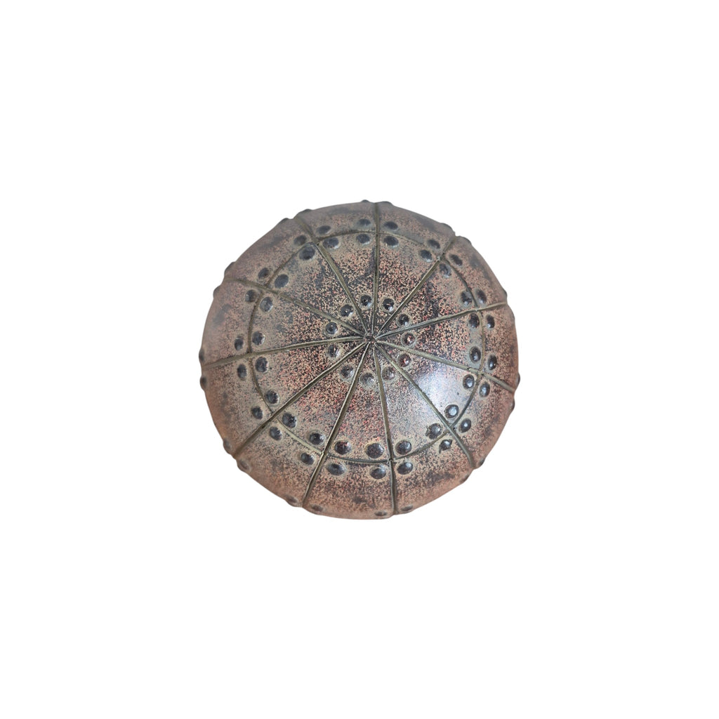 Nordic Rivet Decorative Ball Copper — top-down view showing radiating star-panel detail with raised rivet studs across warm copper-bronze textured resin surface