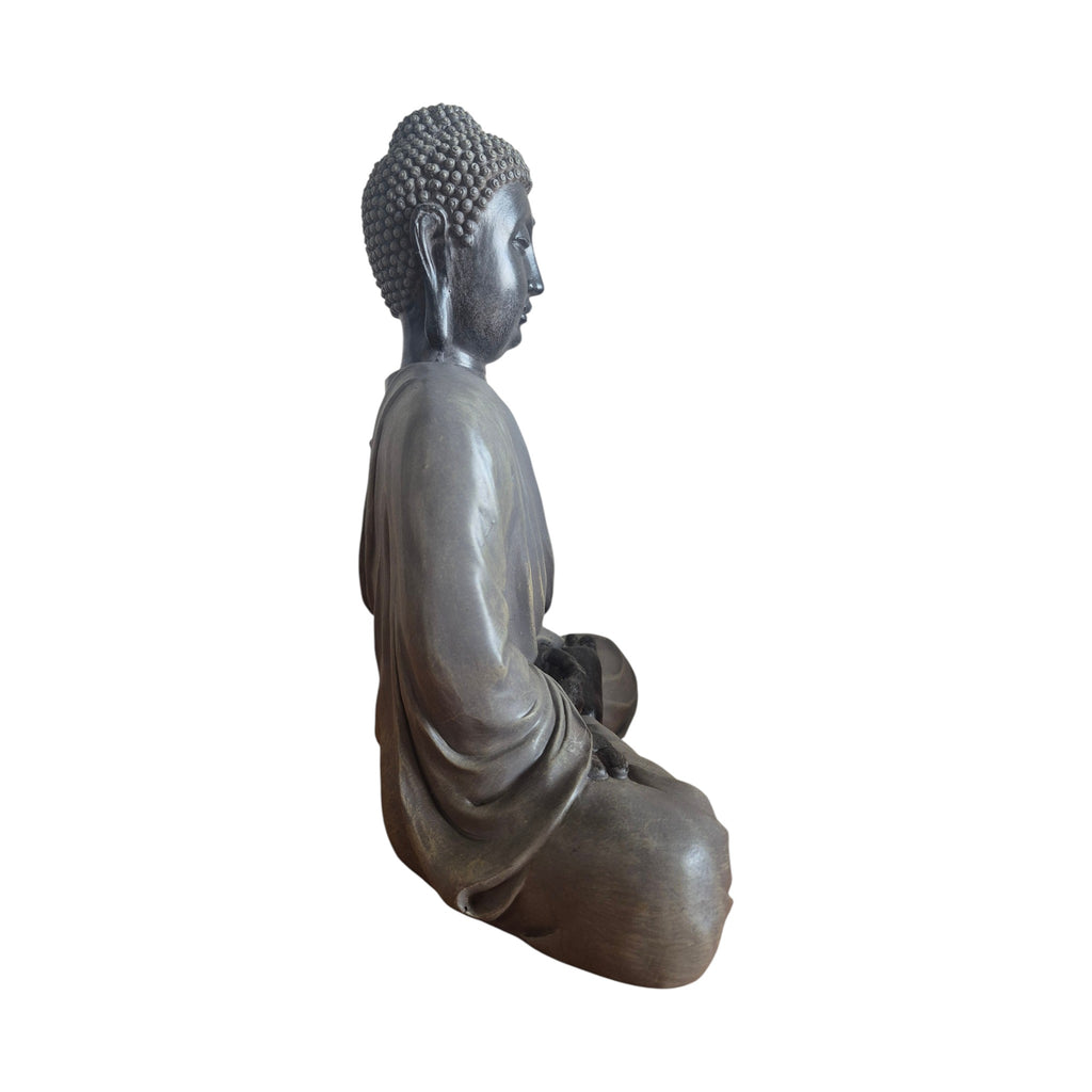 Side view of black and grey meditating Buddha showing draped robe