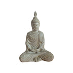 Side view of cream meditating Buddha showing tall hair ornament and draped robe