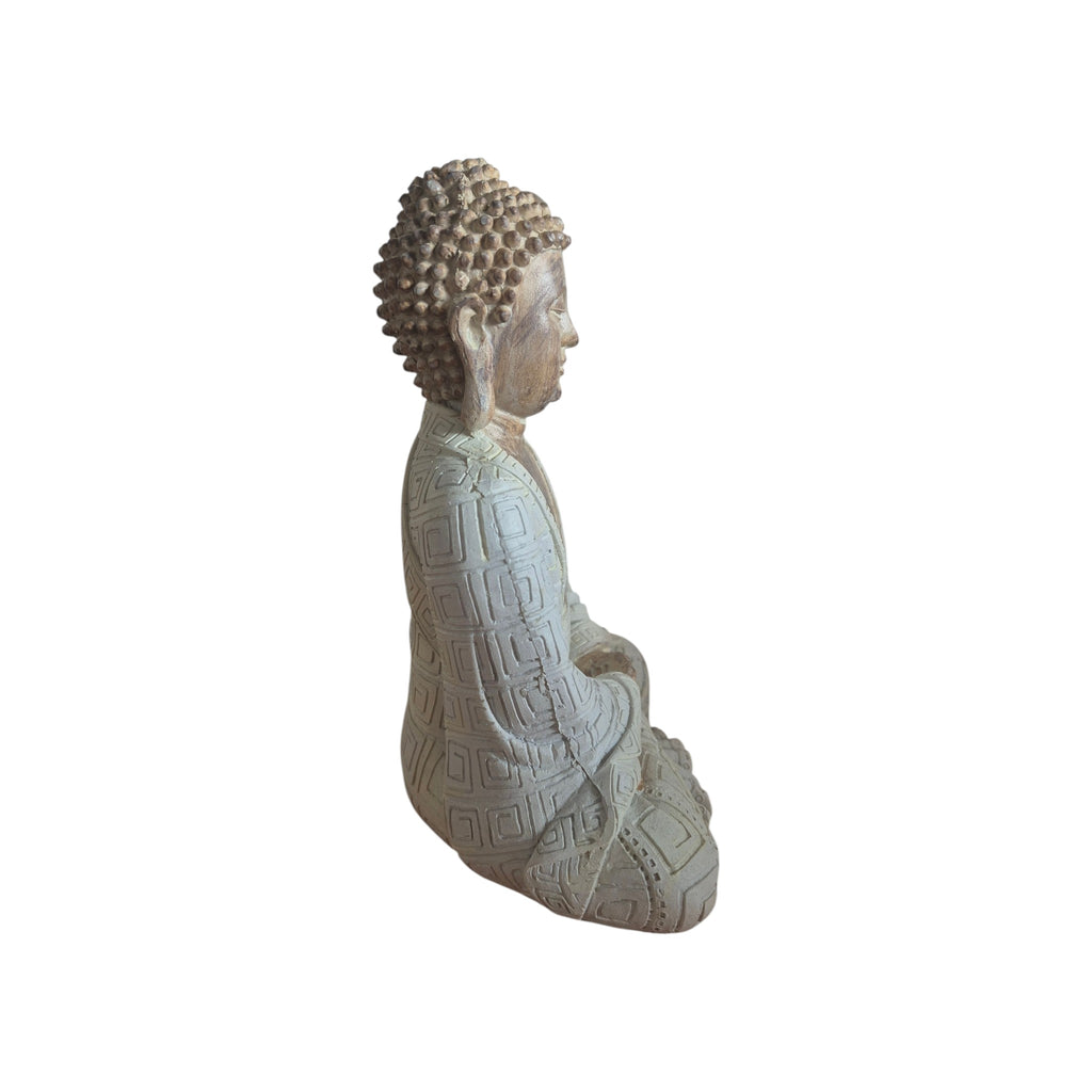 Front view of wood-look meditating Buddha seated with hands in lap and patterned pale robe