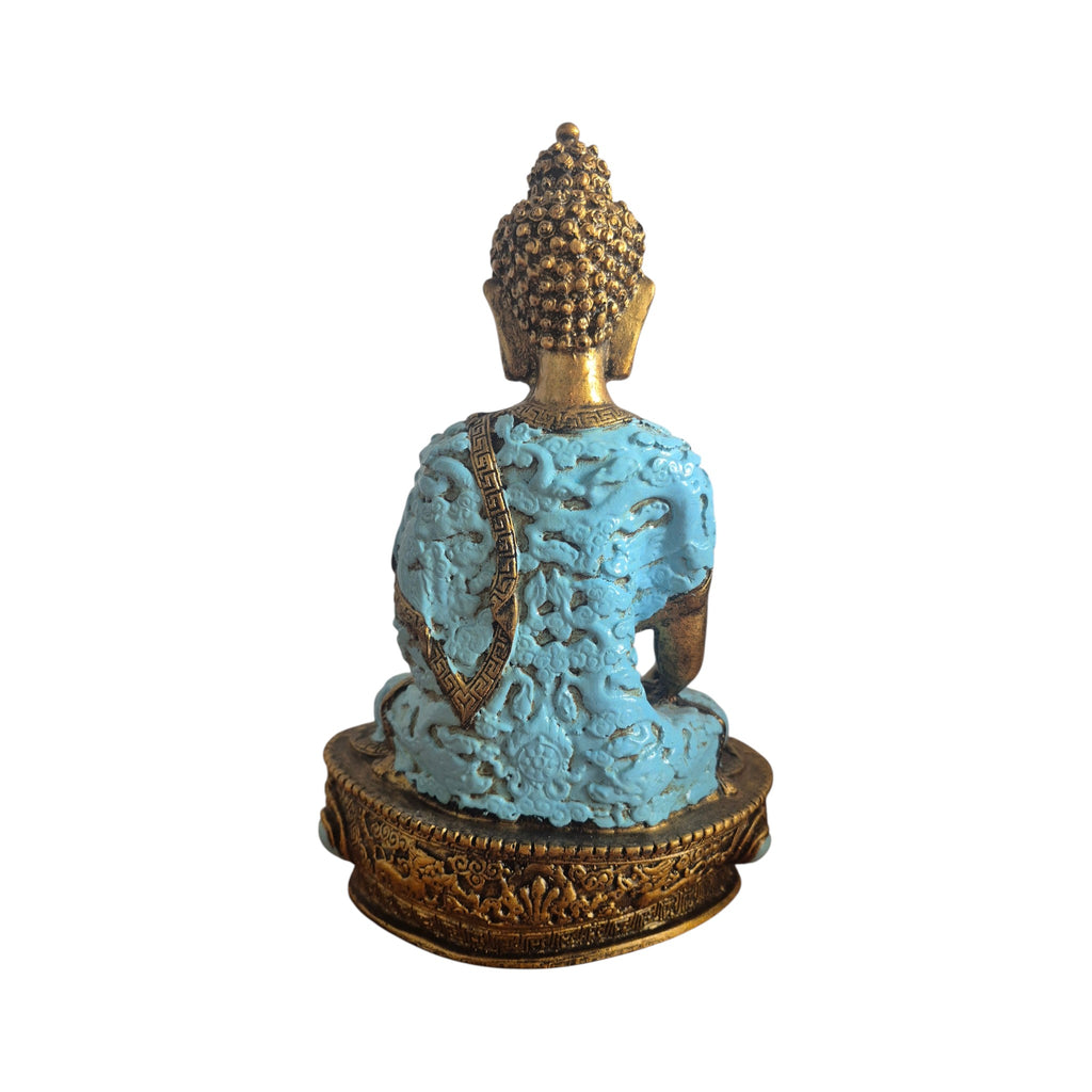 Side view of turquoise Buddha with raised-detail robe and gold-coloured base