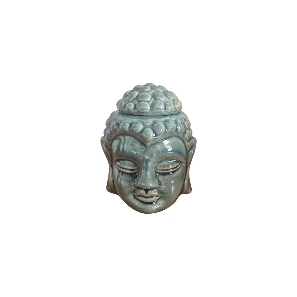 Top view of blue-grey Buddha head oil burner with removable cap beside bowl