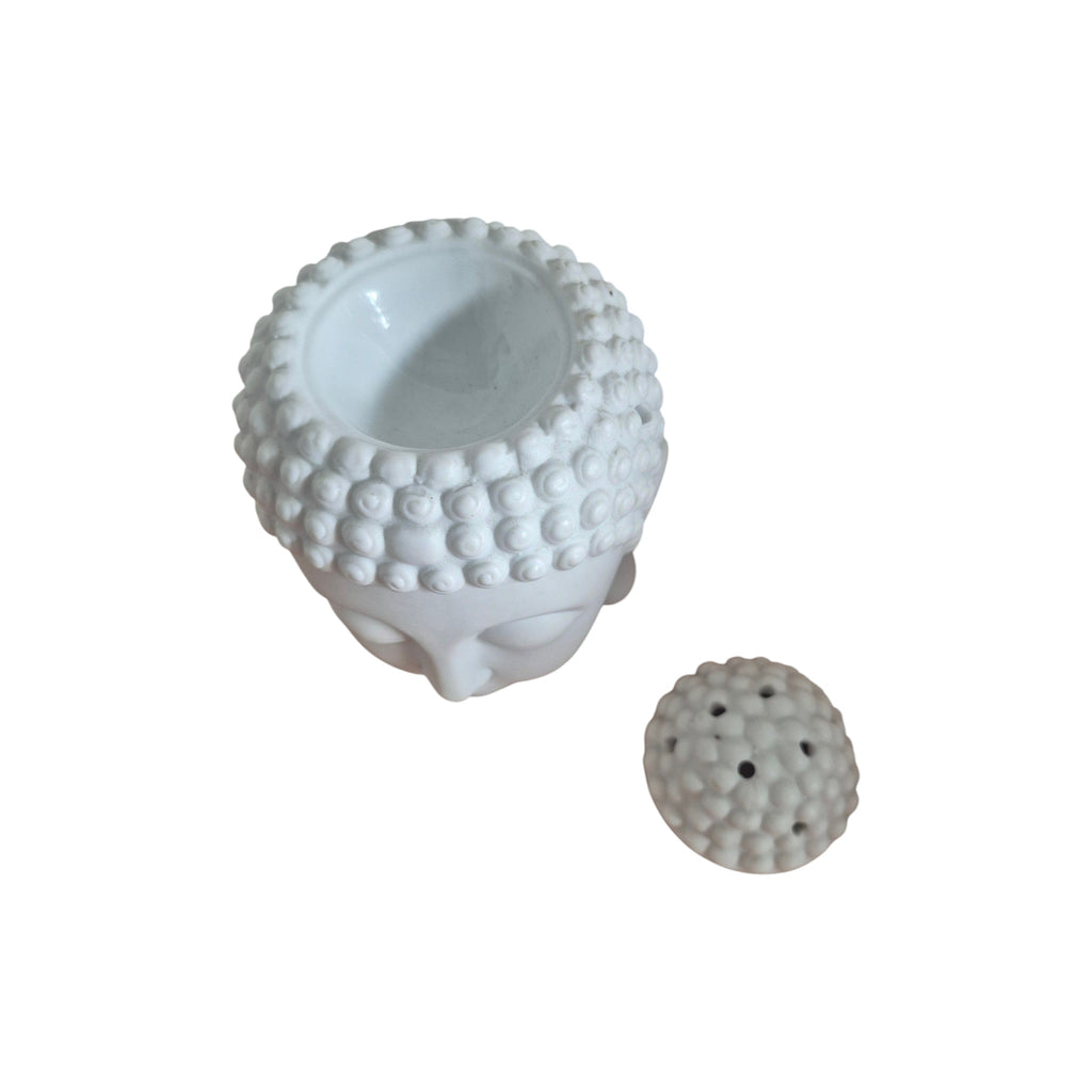Front view of white Buddha head oil burner with serene face and textured hair