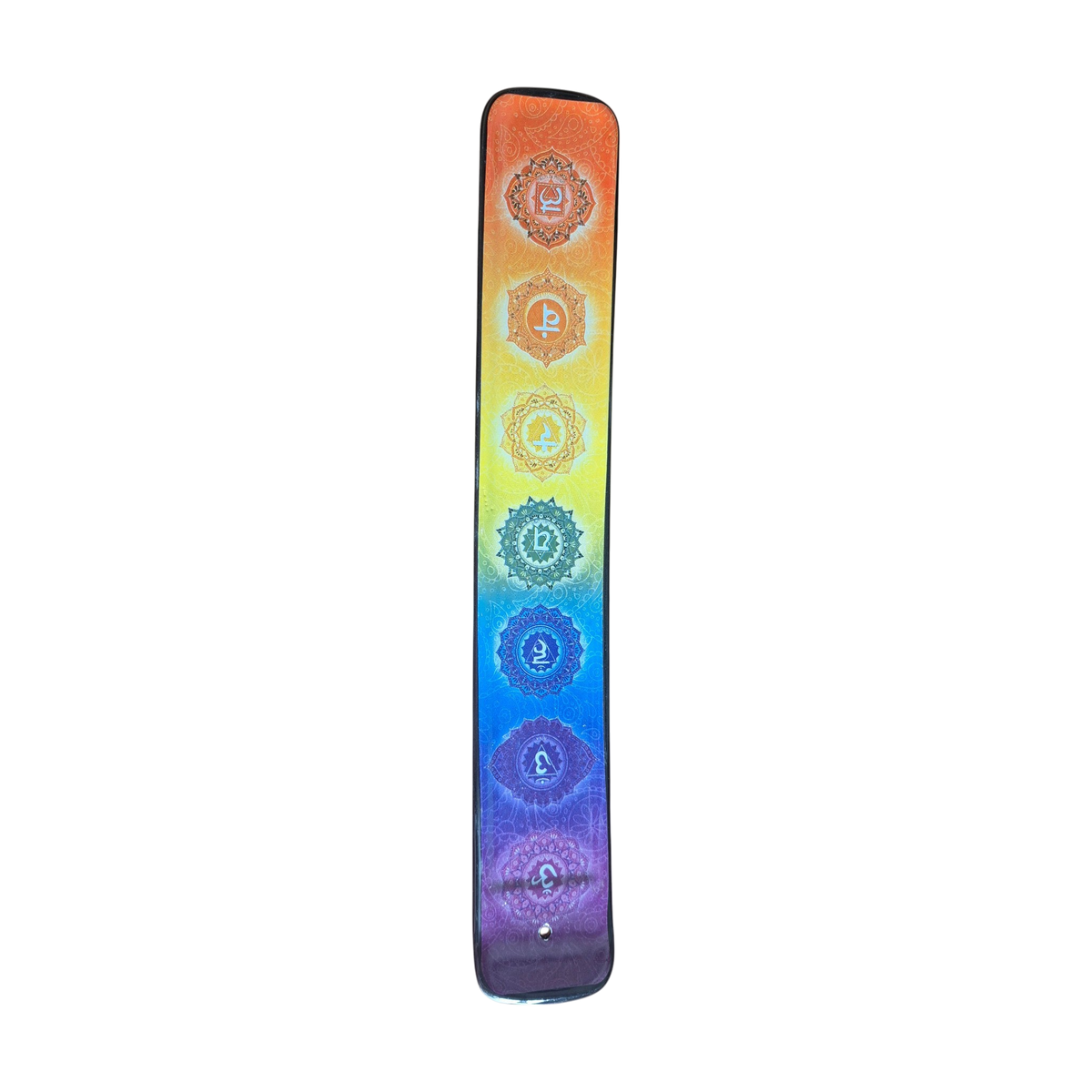 Top of ceramic incense holder with seven rainbow chakra symbols and incense stick hole