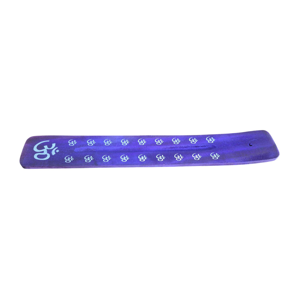Green wooden incense holder with white decorative motifs, angled view