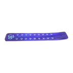Green wooden incense holder with white decorative motifs, angled view