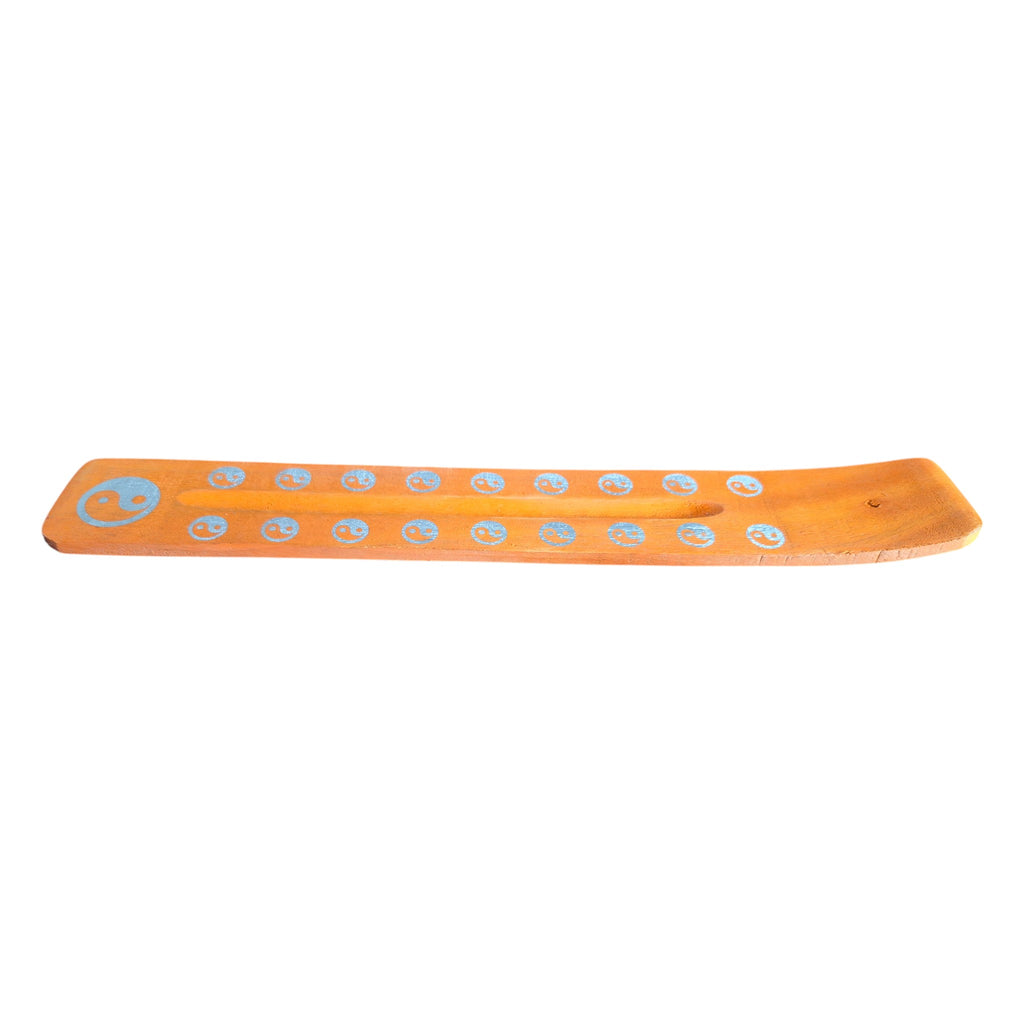 Purple wooden incense holder with Om symbols, angled view