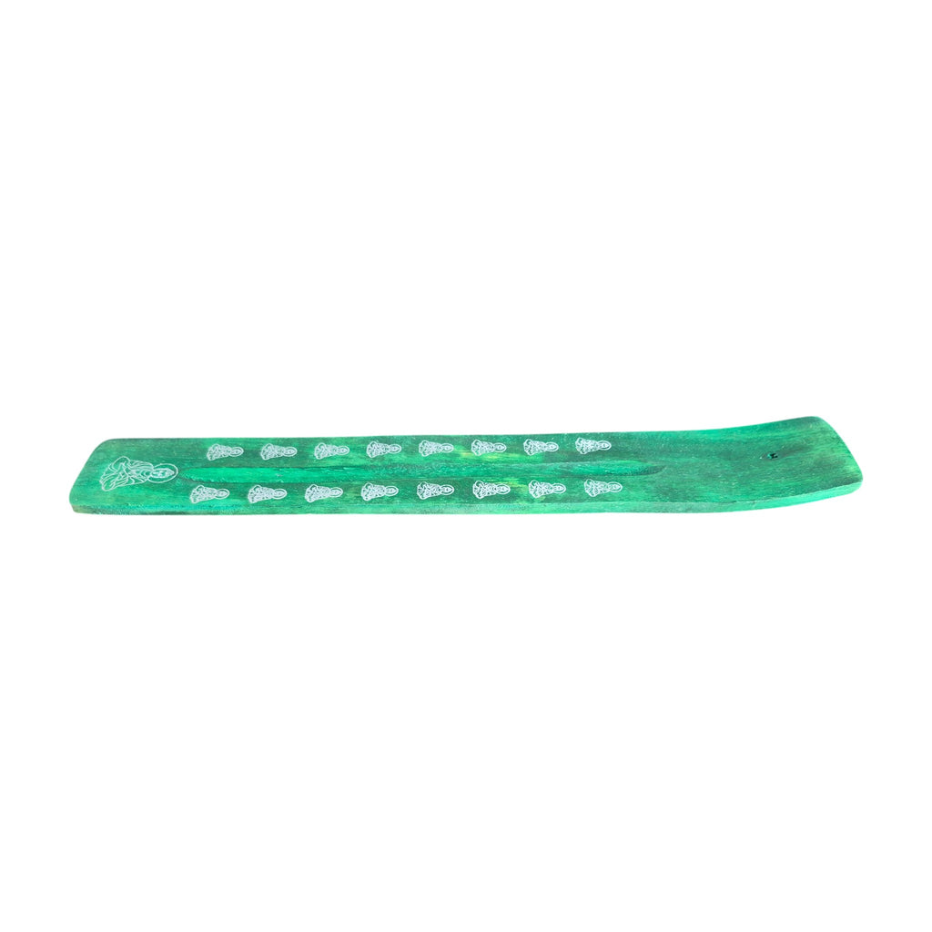 Green wooden incense holder with white motifs, top view