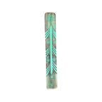 Handmade wooden incense holder with turquoise-coloured carved pattern, angled view