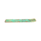 Handmade wood incense holder showing turquoise-coloured detailing and central groove