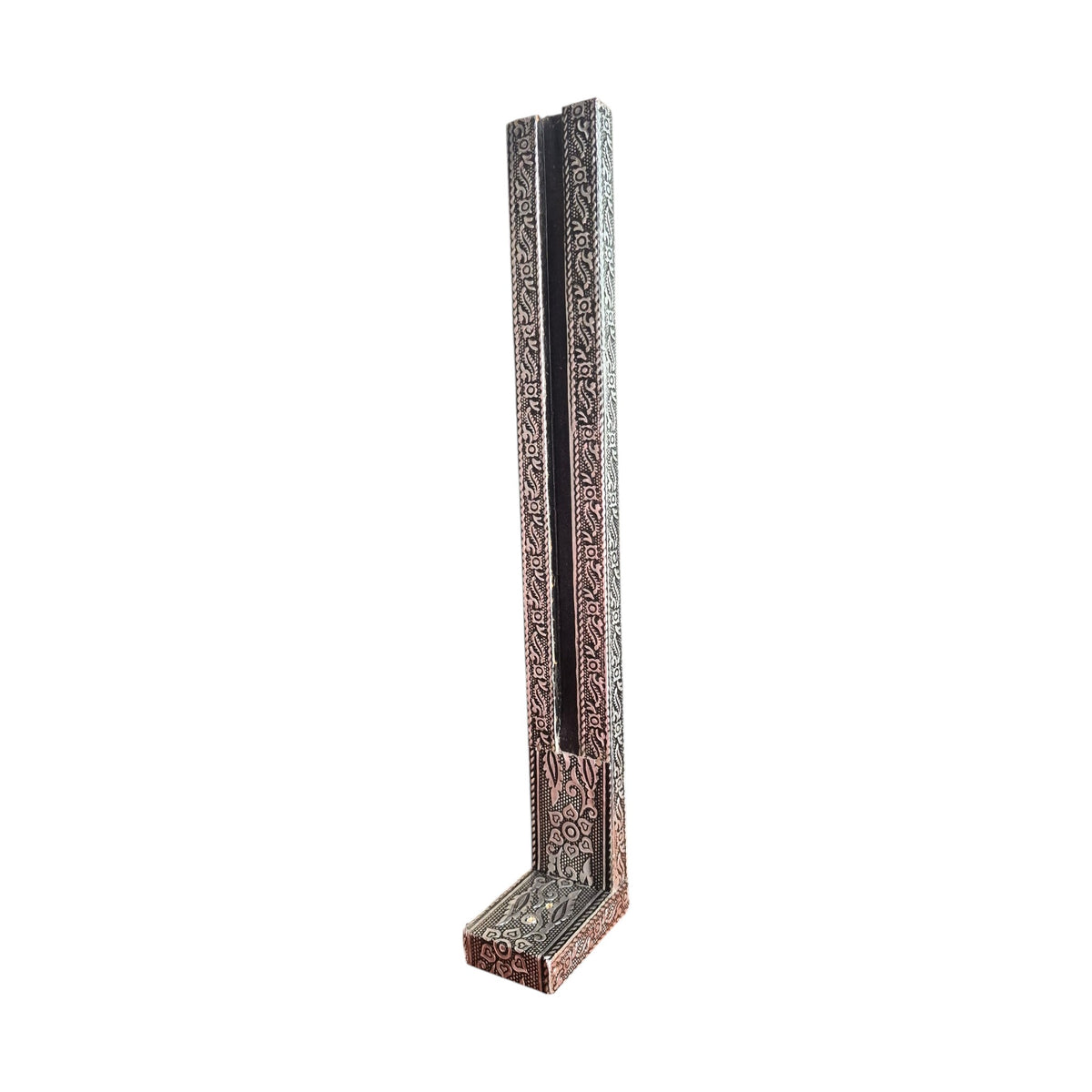 Silver-coloured upright incense stick holder showing patterned frame and base from an angle