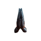 Dark polished praying hands incense stick holder viewed from the front at an angle