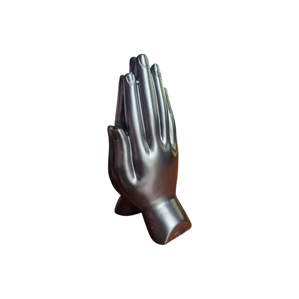 Side view of dark praying hands incense stick holder