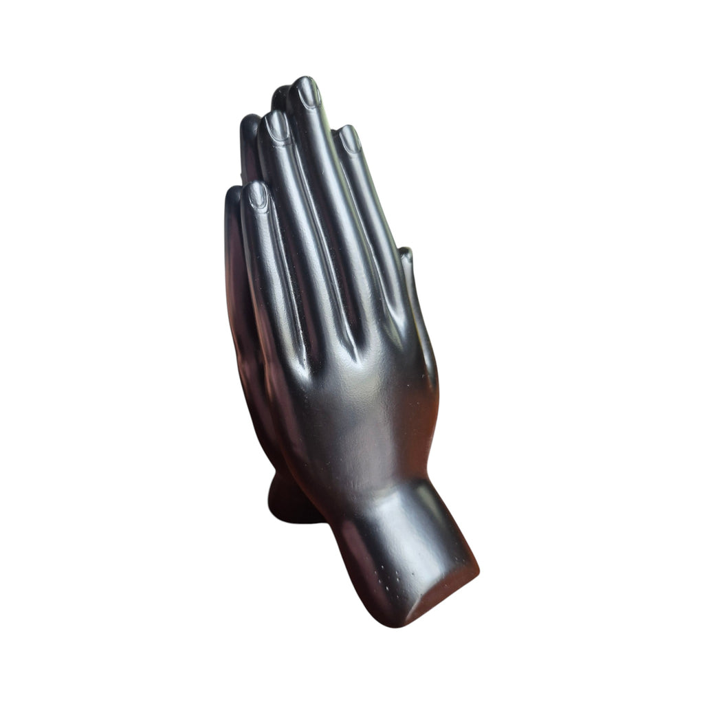 Back view of dark polished praying hands incense stick holder
