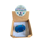 Example teal rainbow agate ring with silver-coloured four-claw setting in display box