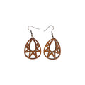 Pair of brown wooden teardrop earrings with open teardrop centres, geometric triangular cut-outs and hook ear wires on white