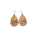 Pair of tan PU leather teardrop earrings printed with floral bull skull and colourful hanging feather motifs, with hook ear wires on white