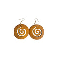 Pair of honey-coloured round wooden drop earrings with spiral cut-outs and gold-tone hook ear wires on a white background