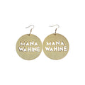 Pair of pale wood round drop earrings with cut-out MANA WAHINE lettering and gold-tone hook ear wires on a white background